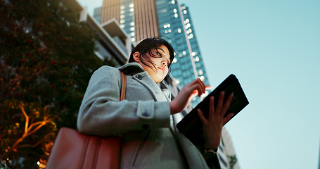 Image showing Asian woman, tablet and city for communication, research or social media by building in Japan. Female person or employee on technology for online search, chat or outdoor networking in an urban town