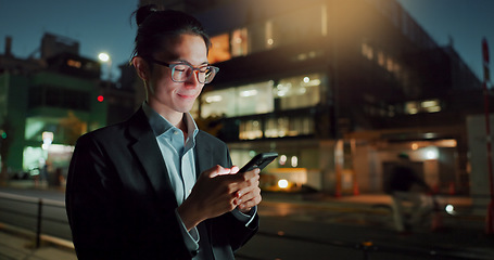 Image showing Businessman, phone and typing at night in city for communication, social media or outdoor networking. Happy asian man or employee smile on mobile smartphone in late evening for chatting in urban town