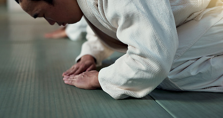 Image showing Asian man, student or bow in dojo for respect, greeting or honor to master at indoor gym. Closeup of male person or karate trainer bowing for etiquette, attitude or commitment in martial arts class