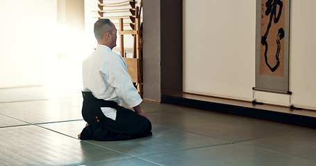 Image showing Asian man, sensei and bow in dojo for honor, greeting or respect to master at indoor gym. Male person or karate trainer bowing in class for etiquette, attitude or commitment in martial arts on floor