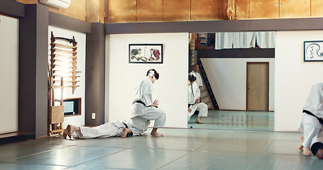 Image showing Students, karate or people learning in dojo for fitness, martial arts discipline or self defense combat. Demonstration, workout or kung fu master training athletes for fighting, education or class