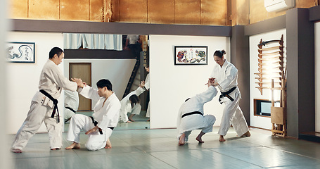 Image showing Students, karate or people learning in dojo for fitness, martial arts discipline or self defense combat. Demonstration, workout or kung fu master training athletes for fighting, education or class