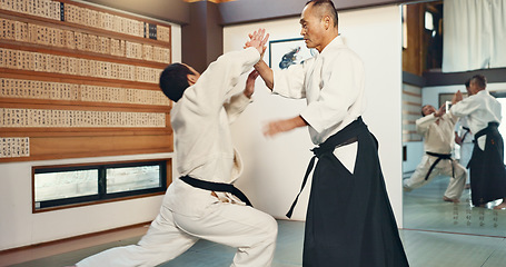 Image showing Aikido, sensei and master in a fight of martial arts with student in self defence, discipline and training. Demonstration, class or Japanese man with black belt in fighting with education of skill