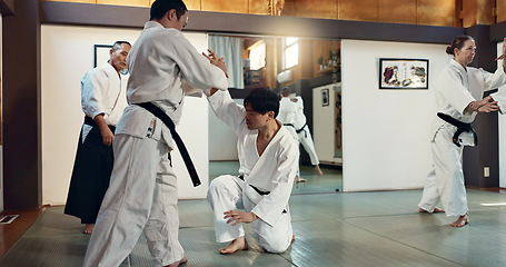 Image showing Martial arts, sensei and Japanese students with training, fitness and action in class for defence or technique. Aikido, people or fighting with discipline, uniform or confidence for culture and skill