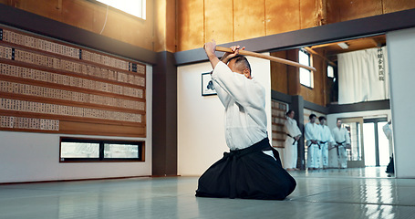 Image showing Aikido sword, mature sensei and man teaching class, self defense or combat technique. Martial arts, Japanese person and wooden weapon for skills development, attack demonstration or bokken strike