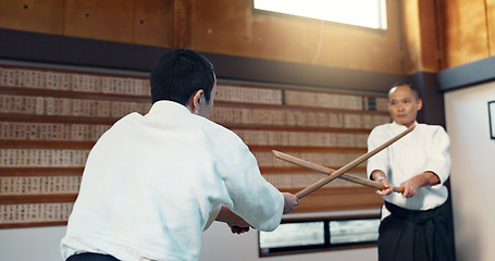 Image showing Asian man, taekwondo and training with wooden sticks for martial arts, fighting or sparring partner in dojo. People in fight practice with dummy weapon to opponent in karate for self defense at gym