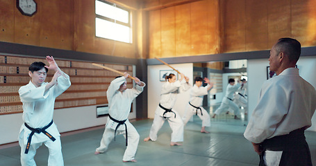 Image showing Martial arts people, aikido class and sensei teaching protection, self defense or combat technique. Black belt students, education and Japanese group learning, skill development and practice in dojo