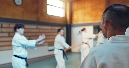 Image showing Japanese men, aikido class and instructor for fighting, modern martial arts and learning self defence. Teacher, students or exercise in life energy, training or strong in active combat for discipline