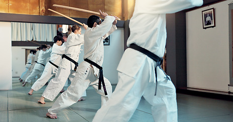 Image showing Martial arts, aikido class and people with training discipline, self defense and practice sword technique. Black belt students, Japanese group and learning skills development for protection in dojo