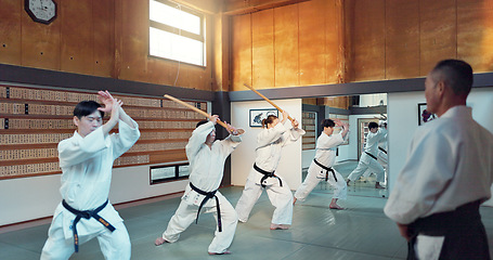 Image showing Martial arts people, aikido class and sensei teaching protection, self defense or combat technique. Black belt students, education and Japanese group learning, skill development and practice in dojo