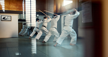 Image showing Aikido, dojo class and people training for self defense, combat and Japanese group practice sword technique. Black belt students, transparent window and learning martial arts for safety protection