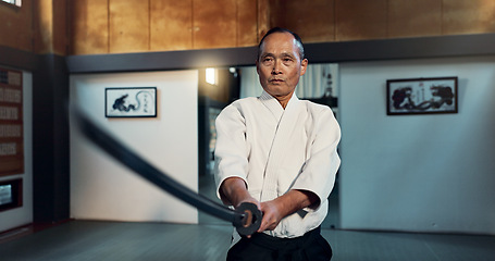 Image showing Aikido sword, martial arts and mature man training, self defense or practice combat technique. Dojo discipline, Japanese samurai or warrior with weapon for skills development, attack or katana strike