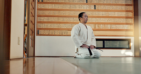 Image showing Martial arts man, bow and floor for fight, training or respect with honor for conflict, competition or dojo. Athlete, Japanese person and preparation for aikido with exercise, workout or discipline