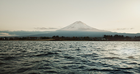 Image showing Mountain, nature and landscape with sea, sky and calm horizon on holiday or vacation. Fujiyoshida, Japan and skyline with trees in summer environment with ocean, water or waves on river shoreline