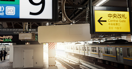 Image showing Railway platform, train and signs with Japanese for commute, travel or journey and transportation. Subway, infrastructure and station with railroad for trip, service or tourism and people in city