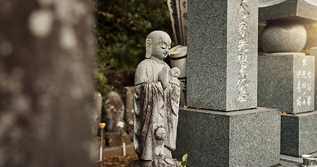 Image showing Buddha, statue and tombstone in graveyard with culture for safety, protection and sculpture outdoor in nature. Jizo, Japan and memorial gravestone with history, tradition and monument for sightseeing