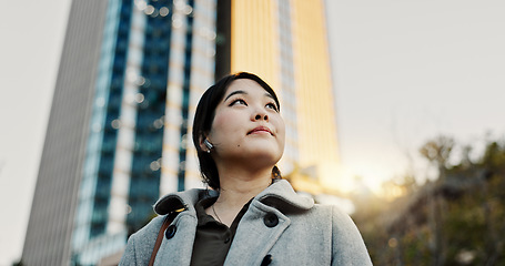 Image showing Thinking, city and professional Japanese woman with music on morning commute, travel and walking in Tokyo. Earphones, corporate and person with ideas, ambition and future for career, business or job