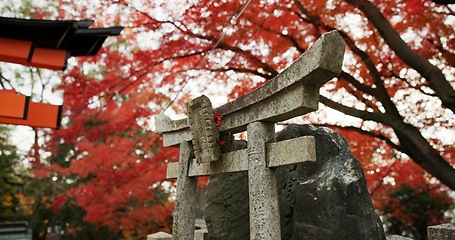 Image showing Statue or sculpture in forest with spiritual history, Japanese culture and vintage art in nature. Travel, landmark and stone nezu jinja shrine in woods with stone monument, trees and worship to god