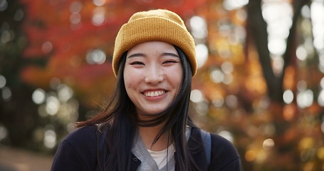 Image showing Woman, forest and portrait in Kyoto, garden and tourist with happiness, traditional history and travel. Nature, japanese culture and explore in woods with trees, adventure and holiday walk in autumn