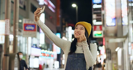 Image showing Heart, hands and selfie by Japanese woman in a city for travel, adventure or journey outdoor. Love, emoji or happy lady influencer in Japan for content creation, blog or social media live streaming