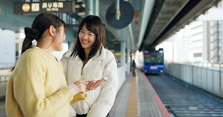 Image showing Women, friends and train station or cellphone or Japanese, travel or social media. Female people, digital device and communication in Tokyo for public transport or vacation commute, urban or journey