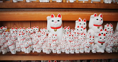 Image showing Japanese, traditional and neko maneki or good luck cat in shop for fortune, culture or heritage. Sculpture figure, gotokuji statue and travel destination in Tokyo for local history, spiritual or gift