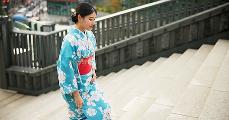 Image showing Stairs, woman in a city and walking with traditional outfit, travel and fresh air with wellness, comfort and peace. Japanese person, kimono and girl with culture, movement and thinking with clothes