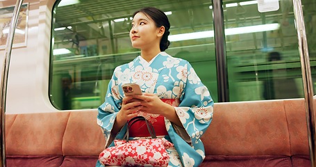 Image showing Woman, japanese and train, phone and kimono with travel, public transport and metro bullet in city. Person, journey or traditional clothes for fashion, weekend and commute in tokyo on adventure