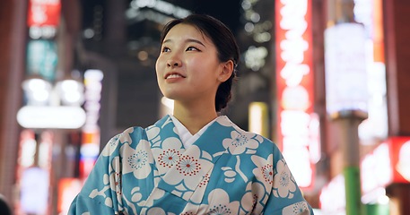 Image showing Thinking, Japanese woman and smile with decision, travel and opportunity with wonder, night and lights. Person, outdoor and girl in the streets, relax and evening with peace, commute and thoughts