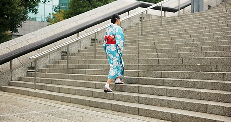 Image showing Woman, Japanese and walking in kimono for traditional on stairs in Tokyo for wellness, health or peace. Female person, outdoor and urban city explore for downtown commute for local, steps or culture