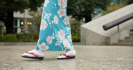 Image showing Person, Japanese and feet walking in kimono in city or local commute or traditional, outdoor or downtown. Legs, sandals and Tokyo street or urban road journey as healthy wellness, culture or trip