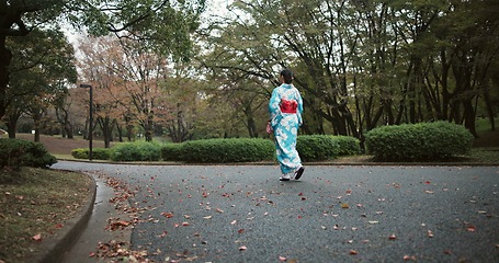 Image showing Back, walking and Japanese woman with traditional clothes, fresh air and wellness with hobby, routine and activity. Person, nature and girl with culture, peaceful and calm with adventure and journey