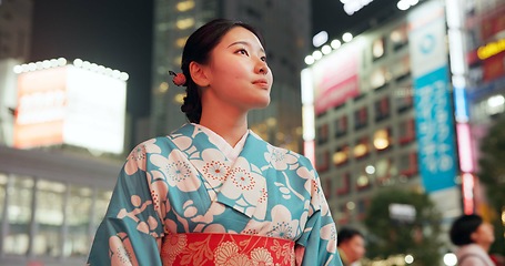 Image showing Thinking, night and city with Japanese woman, journey and opportunity with traditional clothes, wonder or travel. Person, outdoor or girl in the streets, adventure or peace with thoughts or culture