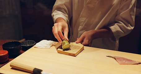Image showing Hands, cooking and wasabi with sushi chef in restaurant for traditional Japanese cuisine or dish closeup. Kitchen, salmon roll or seafood preparation and person working with gourmet meal ingredients