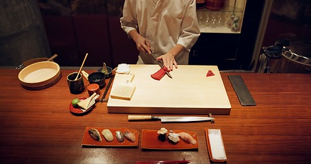 Image showing Hands, cooking and sushi with chef in restaurant for traditional Japanese cuisine closeup from above. Kitchen, seafood dish preparation and person working with gourmet meal recipe ingredients