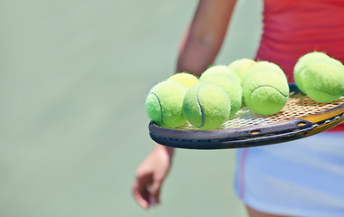 Image showing Woman, tennis player and balls on racket for outdoor game, match or competition on court. Closeup or hands of female person or athlete in sports with bat and equipment for training on mockup space