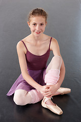 Image showing Portrait, ballerina and happy girl on floor in studio to practice, student exercise or education. Ballet, young teenager and training, dance choreography or art performance class at school in Canada