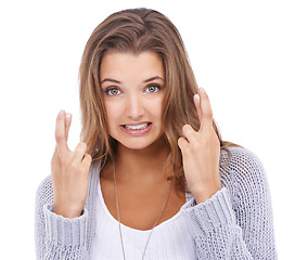 Image showing Nervous woman, portrait and hope with fingers crossed in studio for lucky news, feedback and waiting on white background. Model, worry and hand sign for wish, emoji and praying for lottery results