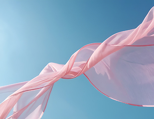 Image showing Flying pink fabric wave on blue sky background and illuminated b