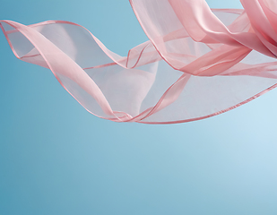 Image showing Flying pink fabric wave on blue background and illuminated by su