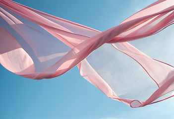 Image showing Flying pink fabric wave on blue sky background and illuminated b