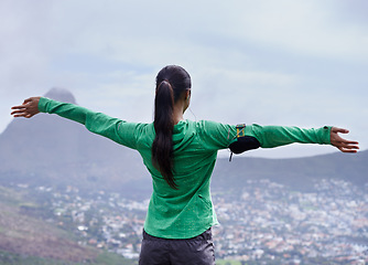 Image showing Hiking, achievement and back of woman on mountain with pride, freedom and celebration in nature of Cape Town. Outdoor, fitness and person with success in landscape on hill with skyline of city