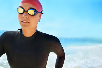 Image showing Sports, goggles and woman swimming at the beach with blue sky for triathlon, race or competition training. Female Swimmer, athlete or person in ocean or sea for fitness workout or exercise for health