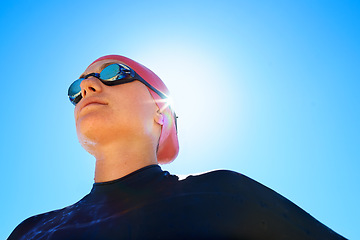 Image showing Swimmer, woman with low angle and athlete outdoor, blue sky with sunshine and water sport for fitness. Exercise, training for swimming and workout, summer and lens flare with mockup space and goggles