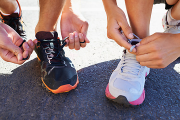 Image showing Shoes, hands and people tie laces for run, closeup for fitness and cardio outdoor, athlete team and workout. Training for race, marathon and runner group with sneakers, exercise and sports for health