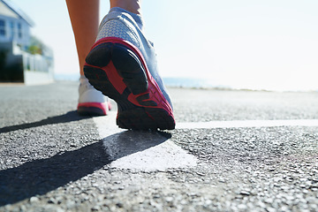 Image showing Feet, rear view and running on street for fitness, health or cardio training in preparation or marathon. Sports, exercise and shoes with athlete person on street for workout, performance or race