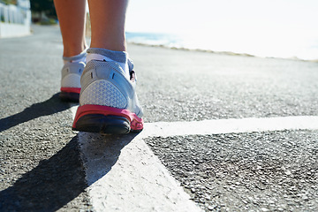 Image showing Feet, rear view and runner on street for sports, health or cardio training in preparation or marathon. Fitness, exercise and running shoes with athlete person on road for workout, performance or race