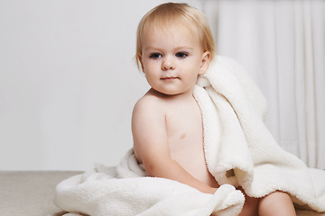 Image showing Baby on bed, clean with towel and bath for morning routine with health, wellness and growth in house. Cute happy toddler in bedroom with hygiene, relax and calm bedtime for child development in home.