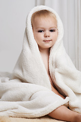 Image showing Portrait of baby on bed, clean with towel and bath in morning with health, wellness and growth in house. Cute happy toddler in bedroom for hygiene, relax or calm bedtime for child development in home