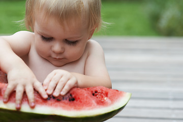 Image showing Boy, playing with watermelon and fruit in backyard, outdoor and development with growth, fruit and home. Toddler, child and infant in garden, alone and childhood to eat, milestone or coordination